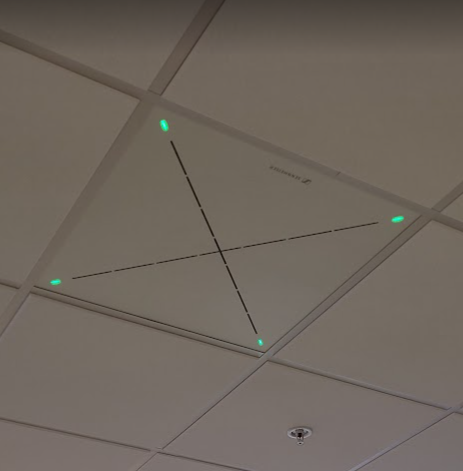 the ceiling tile with microphone has a dotted x symbol